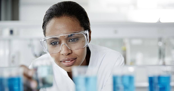 Black college graduate in a science lab