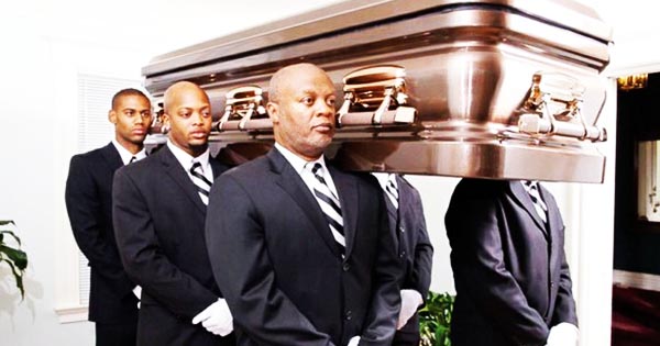 African American men carrying casket at funeral
